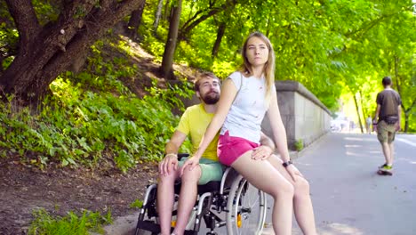 Young-disable-man-on-a-walk-in-the-park-with-his-wife