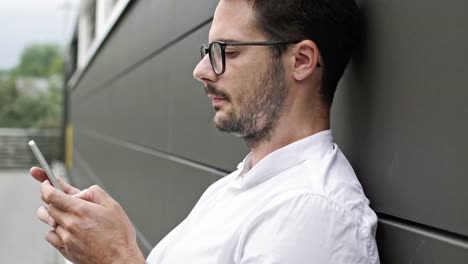 Businessman-typing-on-mobile-phone