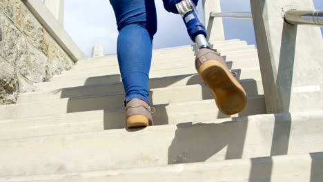 Low-angle-view-of-disabled-woman-walking-upstairs-4k