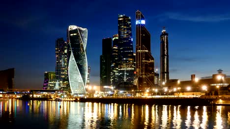 Day-to-night-hyperlapse-of-Moscow-City-(Moscow-International-Business-Center)-and-calm-Moskva-river,-Russia.