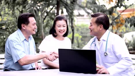 Doctor-and-patient-discussing-medical-examination-outdoor-in-garden.