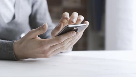 Woman-chatting-with-her-smartphone-at-home