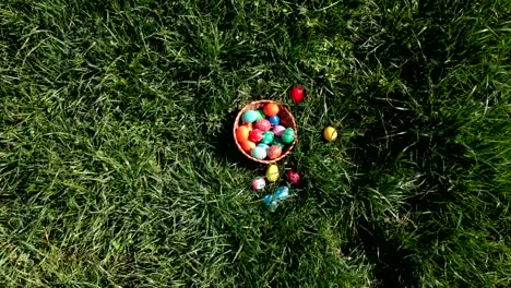 colorful-easter-eggs-in-the-fresh-spring-meadow,-aerial-view