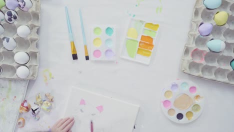 Little-girl-and-her-mom-painting-Easter