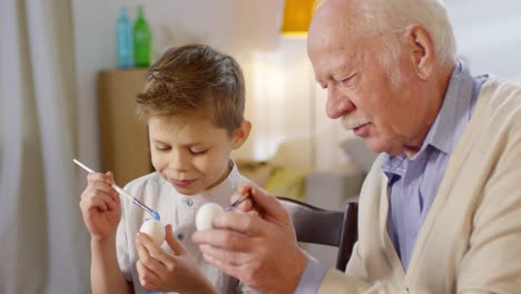 Boy-Learning-to-Paint-Easter-Eggs