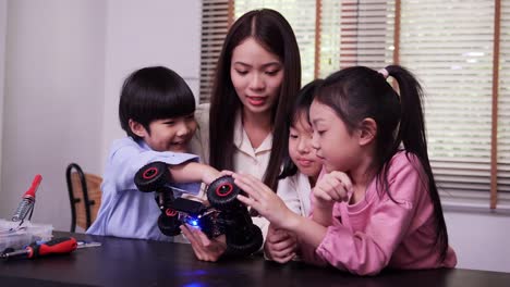 Teacher-and-student-work-on-a-programable-robot-at-school-science-class-project.-Technology-and-Education-concept.