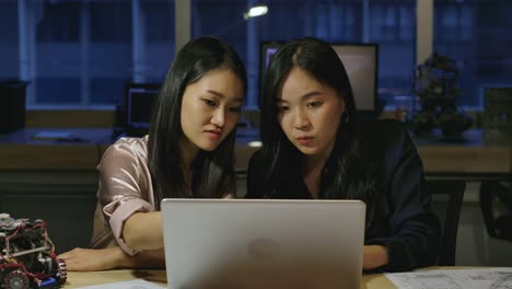 Woman-Electronics-Engineers-Examining-Project-At-Office.-Two-Asian-Female-Compare-Data-On-a-Personal-Computer.-People-with-technology-or-innovation-concept.