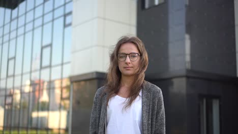 Portrait-of-an-entrepreneur-on-business-center-background.-Slow-motion