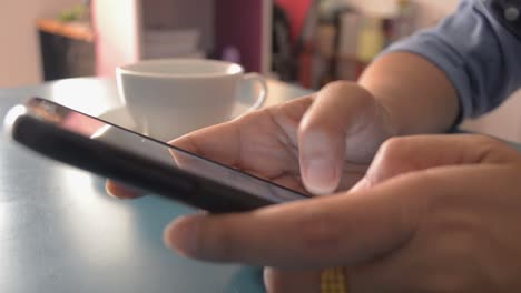 Woman-using-smart-phone-on-the-desk-at-home.