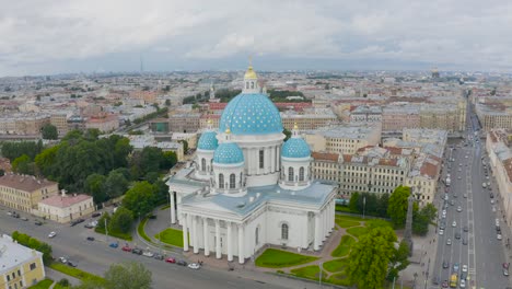 La-famosa-Catedral-de-la-Trinidad-con-cúpulas-azules-y-estrellas-doradas,-vista-de-la-parte-histórica-de-la-ciudad-de-San-Petersburgo,-casas-típicas-alrededor