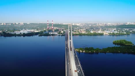 Aerial-drone-of-the-south-bridge,-the-city-of-Kiev.-Ukraine.-Dnieper-river,-the-bridge-crosses-the-river.-Cityscape-aerial-view-bridge-on-the-river-two-guys-climb-to-the-top-of-the-bridge