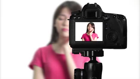 Asian-American-woman-having-eureka-moment-on-camera,-creating-content-for-social-media