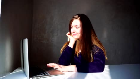 Young-girl-watching-photos-on-laptop-from-travelling