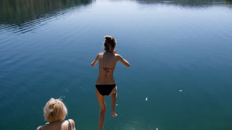 Slender-girl-jumping-into-lake-water