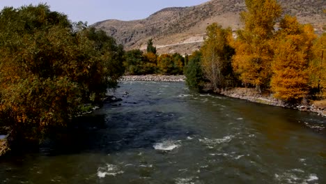 A-river-flows-over-rocks-in-this-beautiful-scene-in-autumn