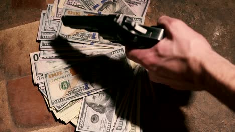 money-and-a-revolver-.-Criminal-concept