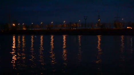 Urban-night-landscape-with-city-lights-reflected-in-water