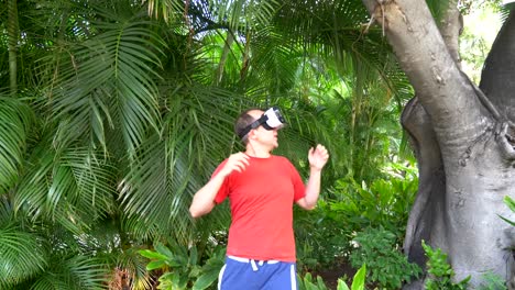 Man-playing-game-in-virtual-reality-glasses-in-tropical-resort-in-4k-slow-motion