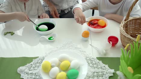 Happy-easter!-mother-and-children-having-fun-paint-and-decorate-eggs-for-holiday