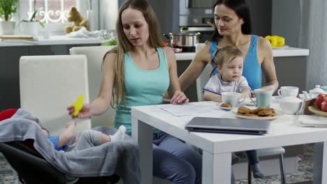 Female-Couple-with-Children-Discussing-Documents