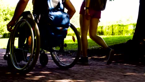 Young-disable-man-with-his-wife-on-a-walk-in-the-park