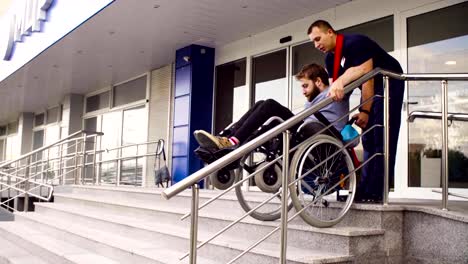 Man-helping-to-move-down-to-a-disabled-man