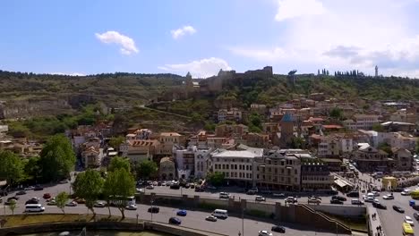 Narikala-Fortress-on-hill,-residential-buildings-at-base-of-mountain,-Tbilisi