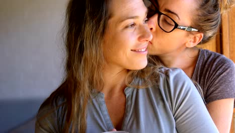 Lesbian-couple-embracing-each-other-at-home-4k