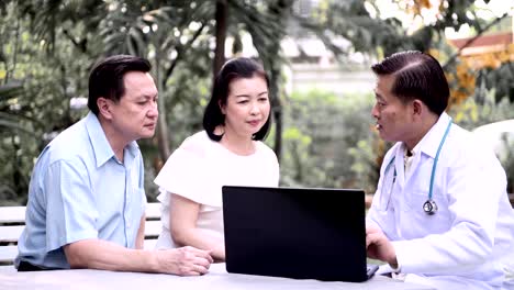 Doctor-and-patient-discussing-medical-examination-outdoor-in-garden.