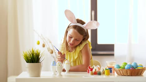 happy-girl-coloring-easter-eggs-at-home