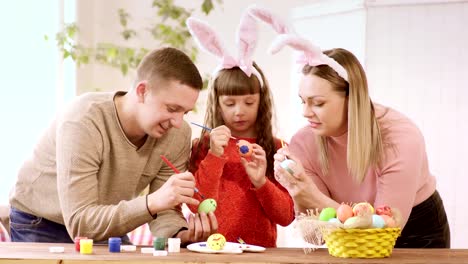 the-family-is-concentrating-on-decorating-Easter-eggs.