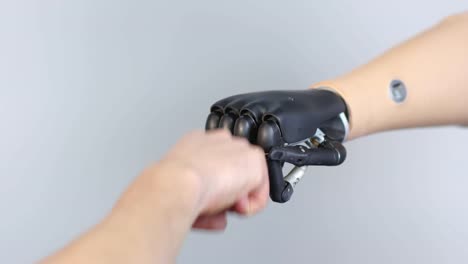 Unrecognizable-Person-with-Prosthetic-Arm-Fist-Bumping