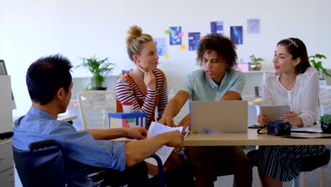 Rear-view-of-a-young-Asian-businessman-sitting-on-chair-while-he-is-discussing-with-others-business