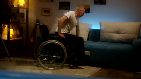 Disabled-man-transferring-from-wheelchair-to-sofa