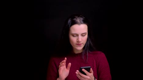 Closeup-portrait-of-young-caucasian-female-browsing-on-the-phone-and-reactinfg-to-social-media-posts