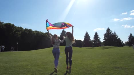 Gay-couple-with-rainbow-pride-flag-running-outdoor