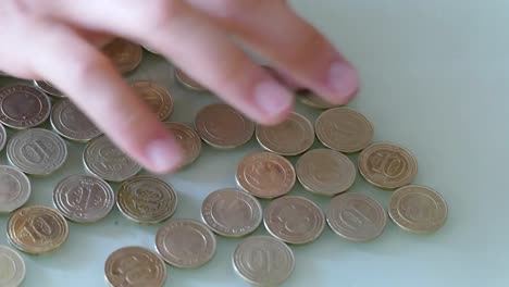 counting-coins,-counting-metal-money-in-a-grocery-store,