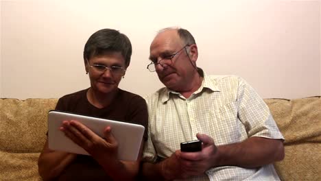 Attractive-adult-woman-and-adult-man-make-a-video-call-with-their-family-on-a-tablet-pc.