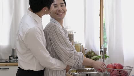 Asian-couple-gay-housekeeping-in-morning-at-home.-Gay-boy-happy-emotion-and-hug-love-anniversary-together.-Concept-of-lifestyle,-family,-gay-and-bisexual.