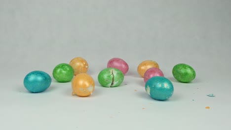 Broken-and-broken-multicolored-easter-eggs-on-white-background,-easter-holiday-graduation-concept,-decorated