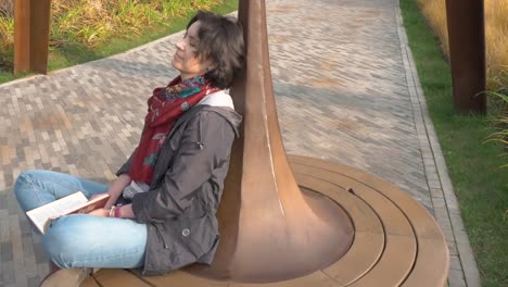 Autumn-day.-Caucasian-woman-rides-on-a-carousel.-Woman-closed-her-eyes.-Enjoys.