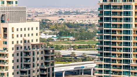 Golf-field-timelapse-from-top-at-day-time-with-traffic-on-sheikh-zayed-road