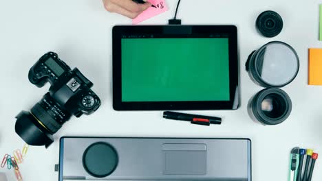 Photographer-working-with-camera-and-laptop-at-his-desk.-View-from-above