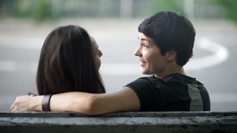 Pretty-lesbians-are-hugging-and-talk-on-a-bench