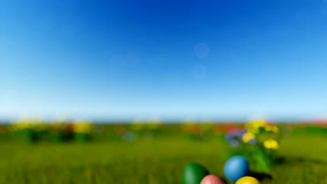 Easter-eggs-on-green-meadow-over-blue-blurry-sky,-tilt