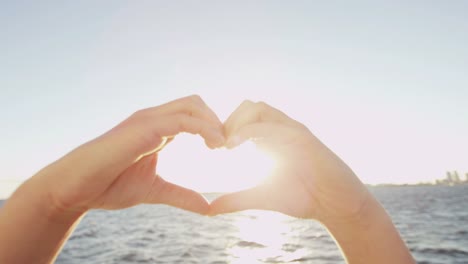 Female-hands-heart-shaped-social-media-message-outdoors