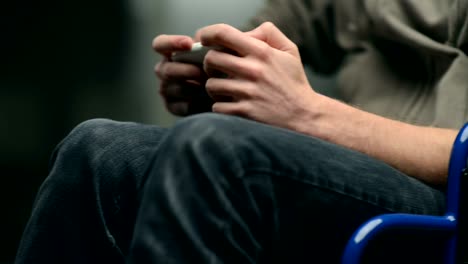 Man-in-wheelchair-using-smartphone