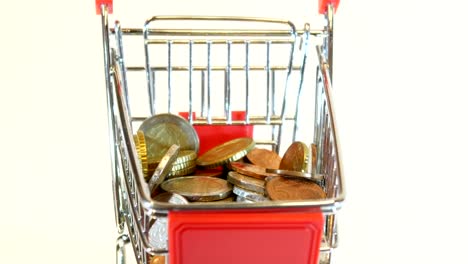 Carrito-de-compras-lleno-de-monedas-de-euro