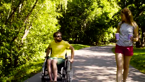 Young-disable-man-with-his-wife-on-a-walk-in-the-park