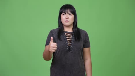 Beautiful-overweight-Asian-woman-giving-thumbs-up